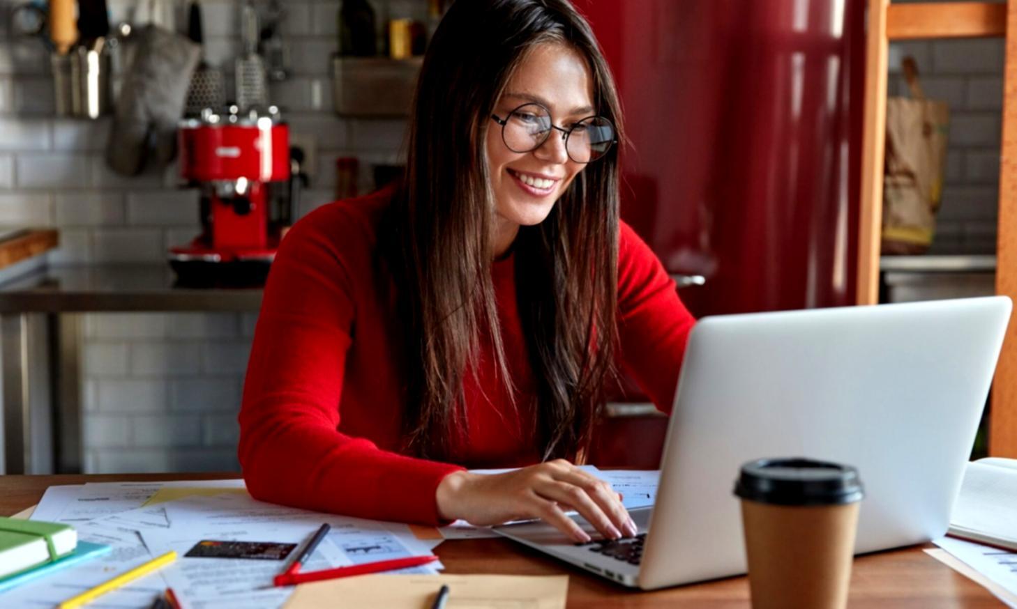 Close-up view of hands typing screenplay format on computer showing proper scene headings and dialogue structure
